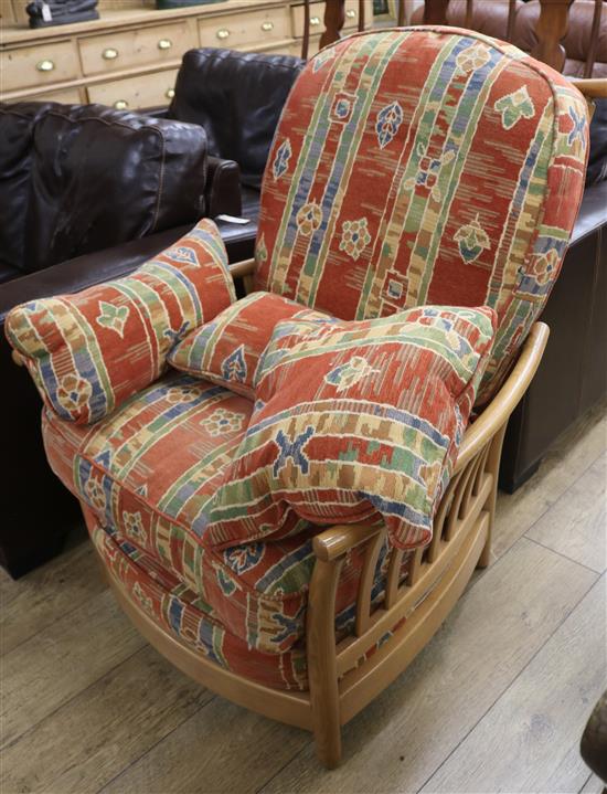 A modern Ercol ash framed armchair with loose cushions